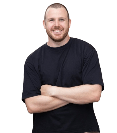 Smiling man in black t-shirt, arms crossed.