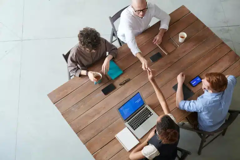 Team of office workers collaborating around table